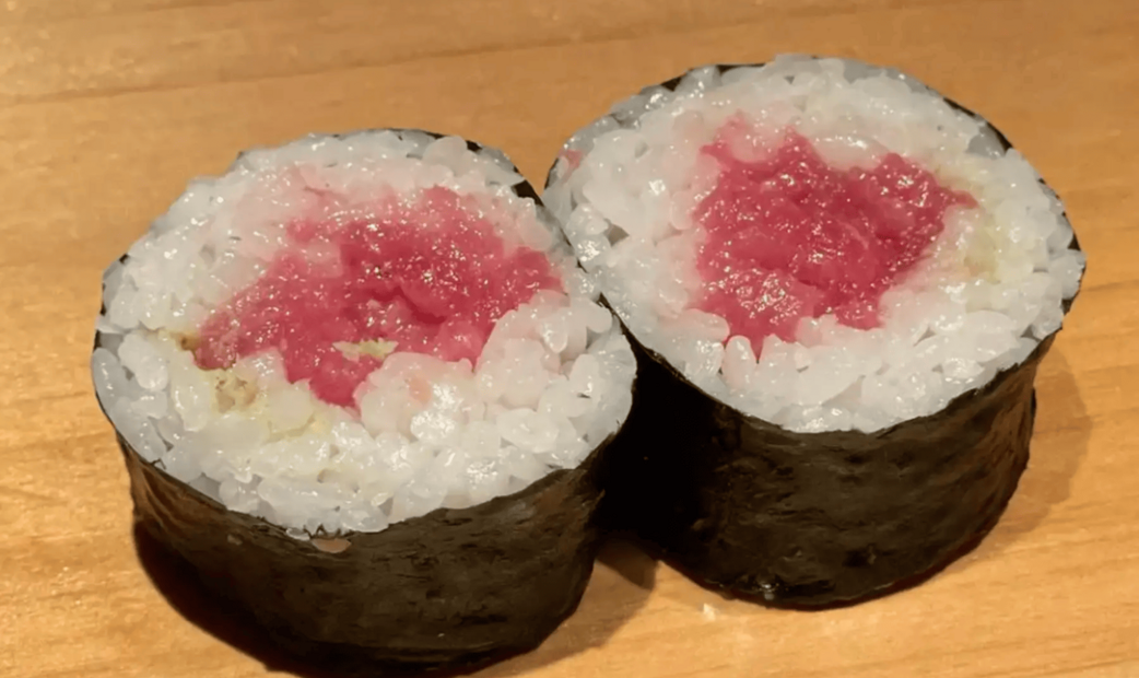 Fresh red fish's maki on wooden plate