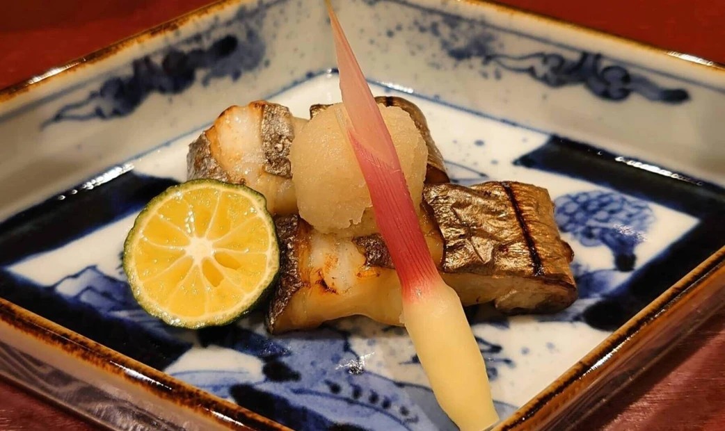 Grilled fish on a blue plate