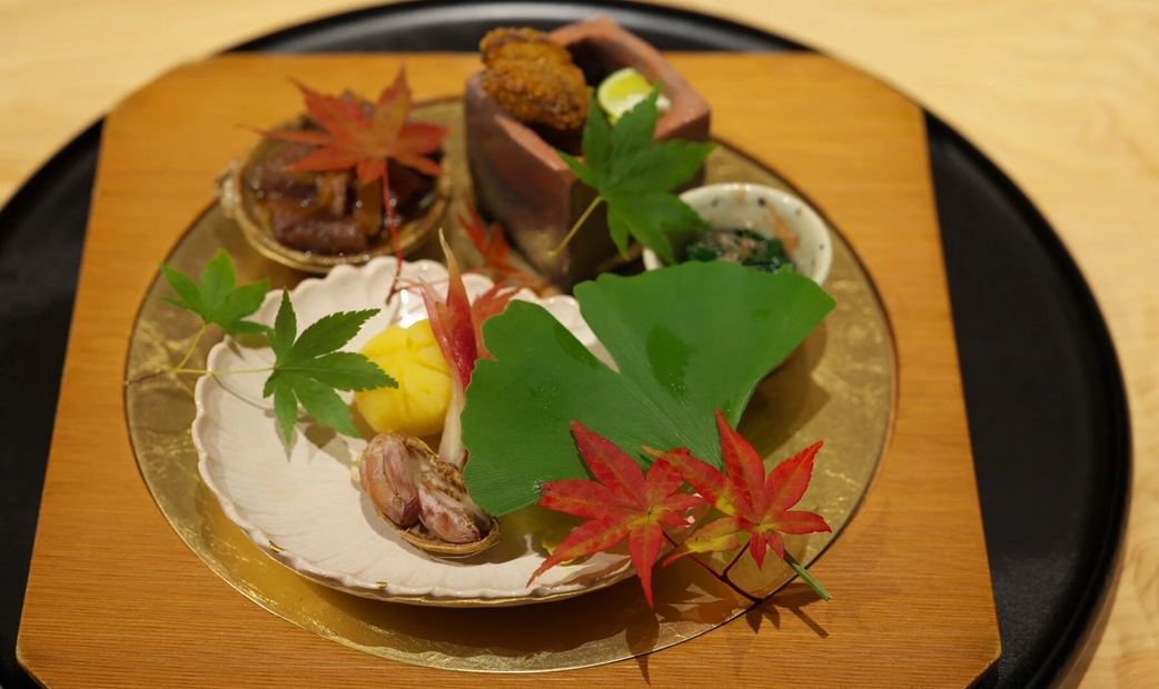 Appetizers on clear and wooden plate