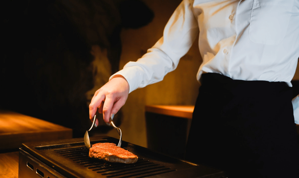 A person grilling meat