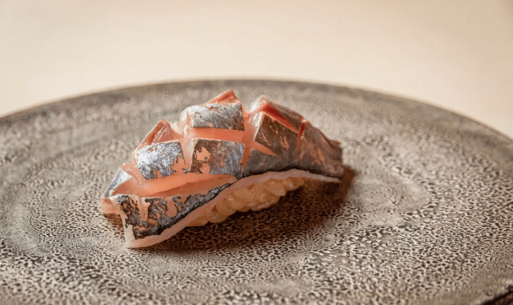 grey and pink-orange sushi on gray plate