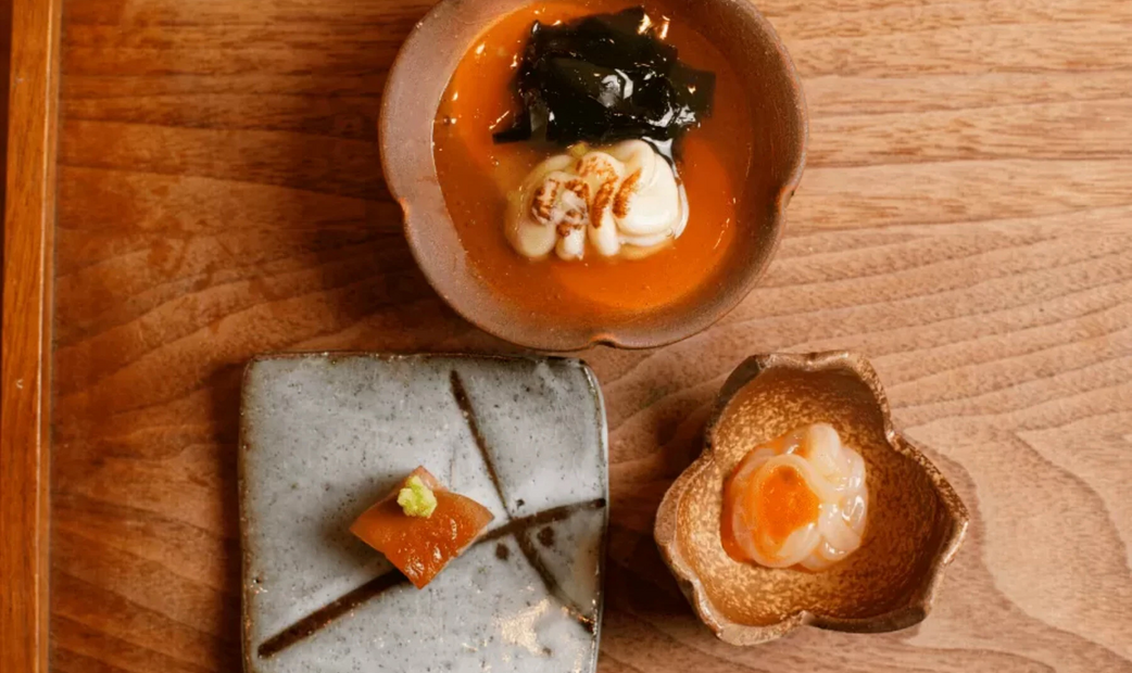 Three Japanese style appetizers on wooden tray