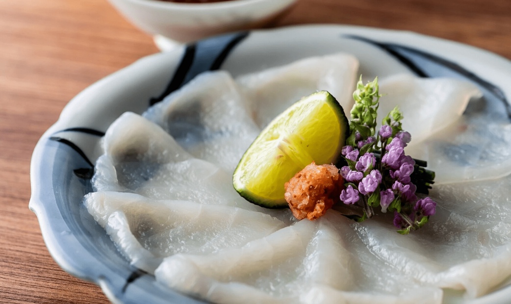 Sliced pufferfish sashimi on a plate