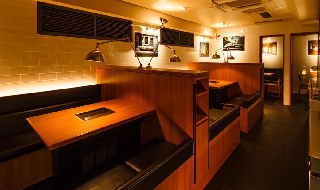 Interior of a cozy restaurant with wooden booths and warm lighting