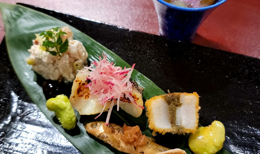 Japanese appetizer on green leaf