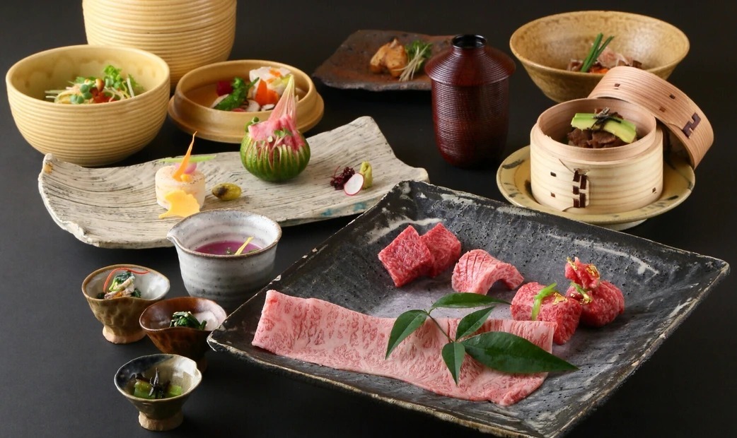 Red meat, a black plate, and a sample course menu.