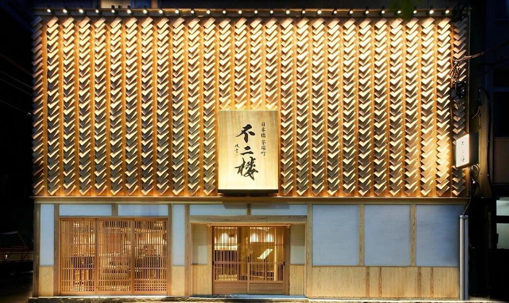 The exterior of a traditional Japanese restaurant with intricate wooden lattice design.