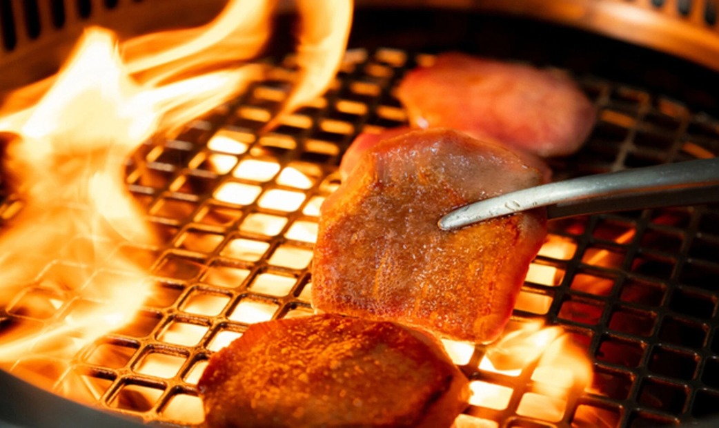 A scene of grilling meat on a mesh grill